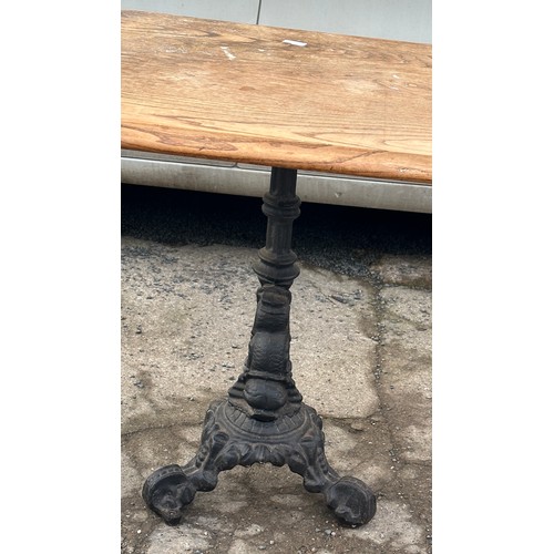 300 - Cast iron base pub table measyres approximately 27 inches tall 26 inches square