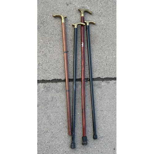 214 - 4 brass topped walking sticks