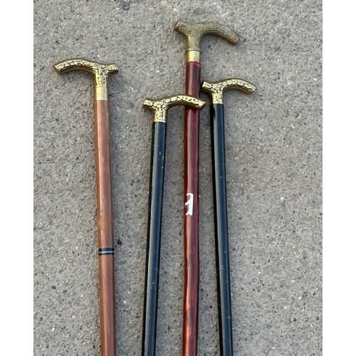 214 - 4 brass topped walking sticks