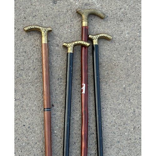 214 - 4 brass topped walking sticks