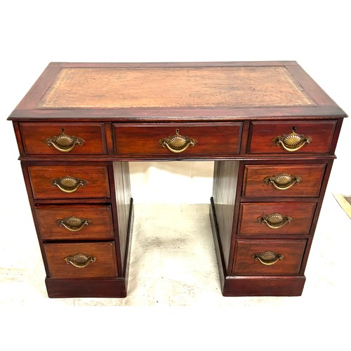 292 - Antique mahogany leather top 9 drawer desk measures approx 27 inches tall by 37.7 inches wide