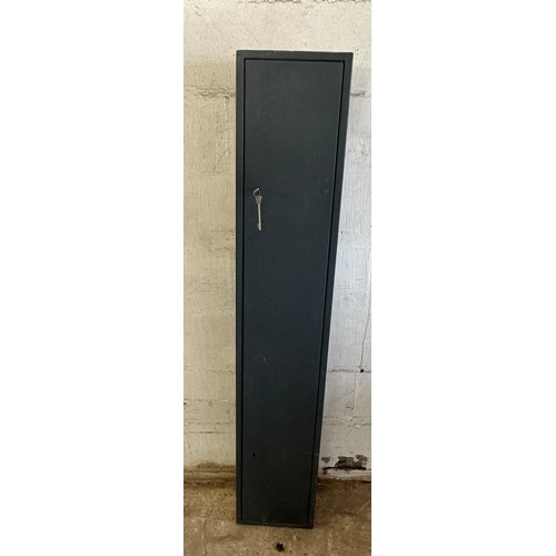 329 - Metal gun cabinet with key measures approx 59 inches tall by 9 deep and 11 wide