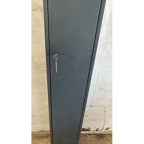 329 - Metal gun cabinet with key measures approx 59 inches tall by 9 deep and 11 wide