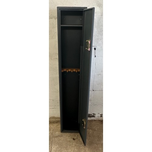 329 - Metal gun cabinet with key measures approx 59 inches tall by 9 deep and 11 wide