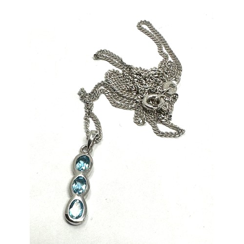 77 - 9ct white gold blue topaz drop pendant & chain (2.5g)