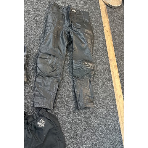 261 - Selection of motor bike shoes and trousers to include Ashman