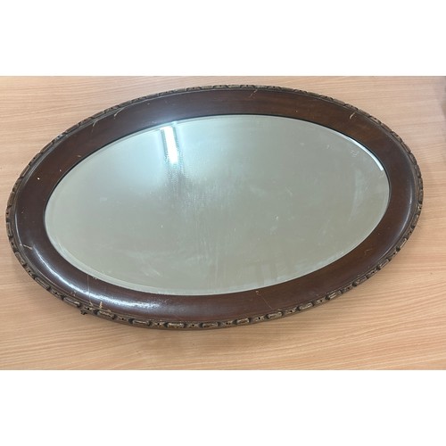 79 - Oval oak framed mirror measures approximately 32 inches wide 21 inches tall