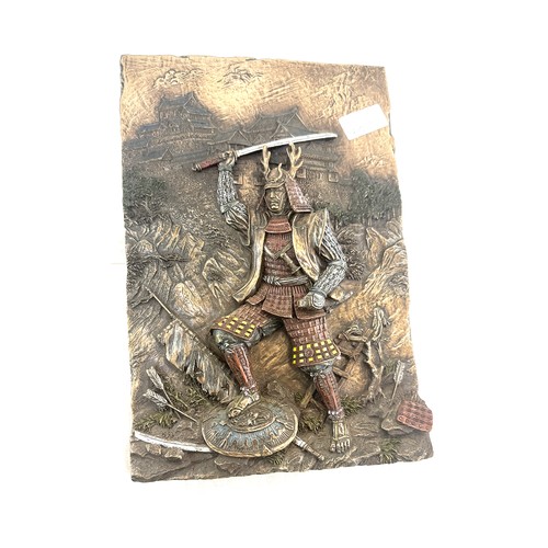 67 - Bronzed plaque depicting a Samuri Warrior measures approx 12 inches long by 8 pieces wide