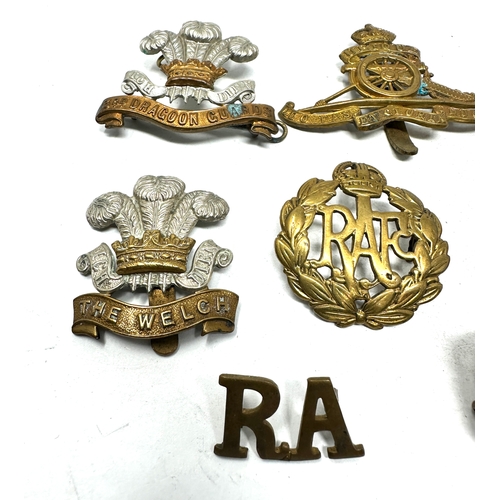 564 - selection of military cap badges etc