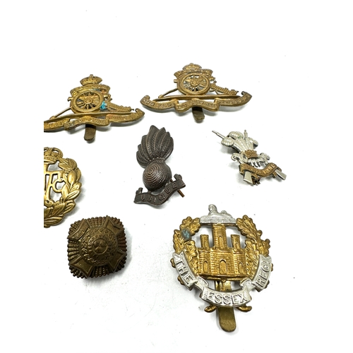 564 - selection of military cap badges etc