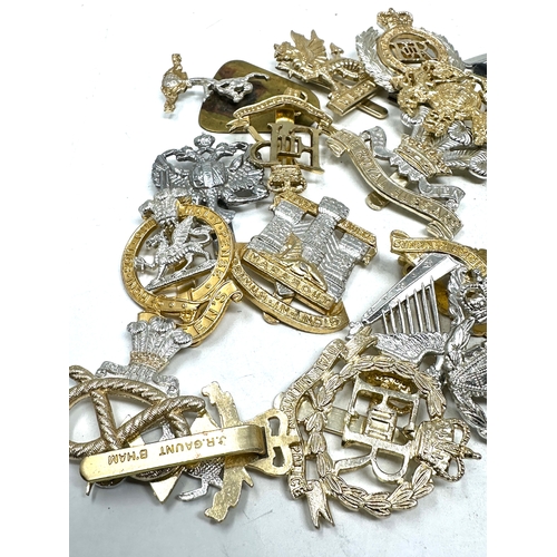 567 - large selection of military cap badges etc