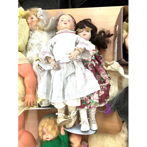 244 - Selection of vintage dolls various sizes to include a vintage wooden dolls cot, additional clothing