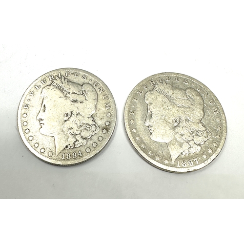 697 - 2 silver morgan dollars 1897 & 1884