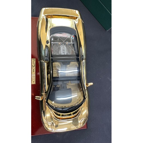 81 - Boxed Jaguar XJ220 a 22 carat gold plate limited edition model car on stand, overall length of car 1... 