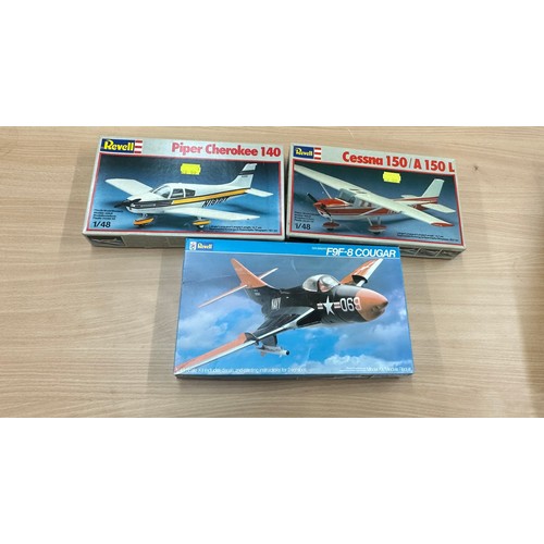 63 - Three Revell air craft model kits to include ' Cessna 150 A150L', 'Piper Cherokee 140', 'F9F-8 Couga... 