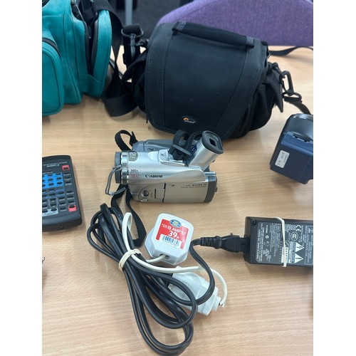 93 - Two cameras with bags and accessories to include Canon Elura and a Panasonic NV-S90 - untested