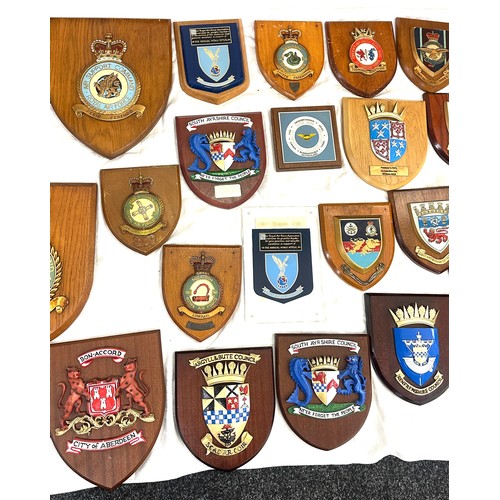 134 - Large quantity of vintage RAF and local authority shields and plaques with squadron insignia and coa... 