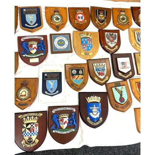 134 - Large quantity of vintage RAF and local authority shields and plaques with squadron insignia and coa... 