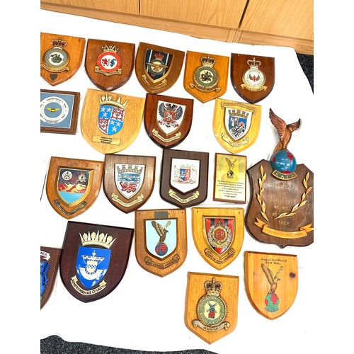 134 - Large quantity of vintage RAF and local authority shields and plaques with squadron insignia and coa... 