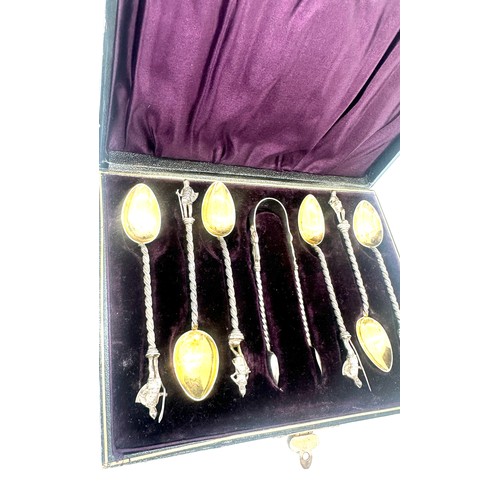 549 - An unusual cased set of six silver spoons and sugar tongs. 830 grade. Bowls marked H.W cast finials ... 