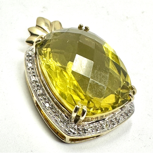 81 - 9ct gold  peridot & diamond pendant measures approx 3.1cm drop by 1.9cm wide  weight 7.5g