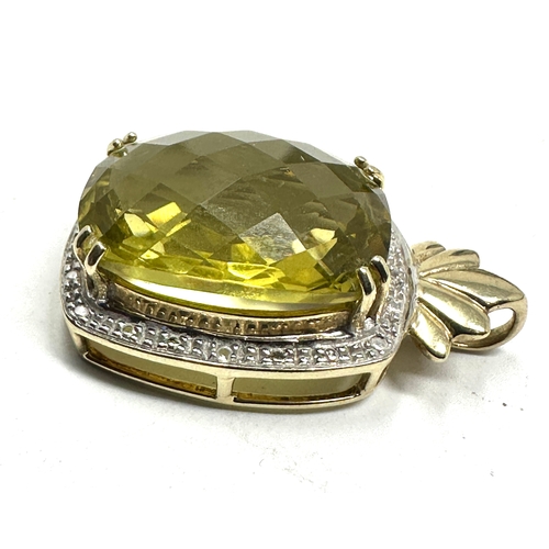 81 - 9ct gold  peridot & diamond pendant measures approx 3.1cm drop by 1.9cm wide  weight 7.5g