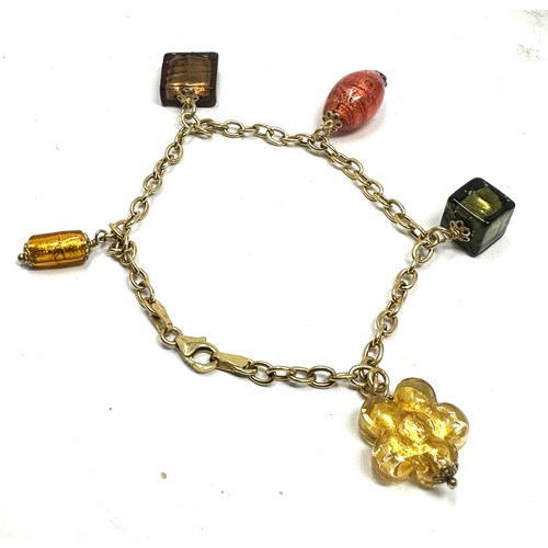 87 - 9ct gold charm bracelet glasss charms weight 10.5g