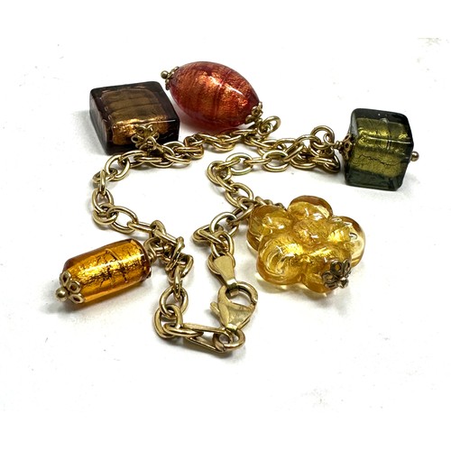 87 - 9ct gold charm bracelet glasss charms weight 10.5g