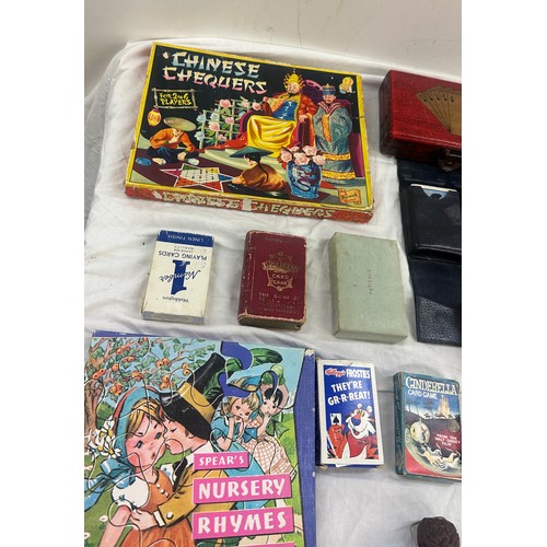 143 - Selection of vintage games, Chinese chequers, nursery rhyme puzzle, Bristol playing cards in leather... 