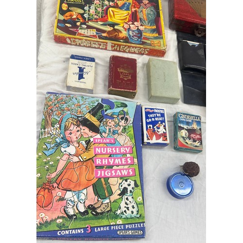 143 - Selection of vintage games, Chinese chequers, nursery rhyme puzzle, Bristol playing cards in leather... 