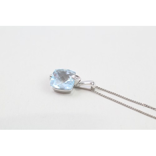 229 - 9ct gold blue topaz & diamond pendant & chain (2.2g)