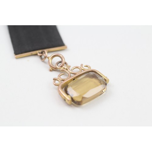 278 - 9ct gold antique citrine fob on a grosgrain extender (8.1g)