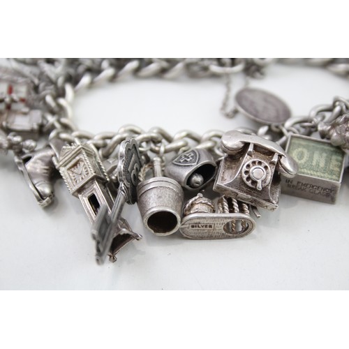 421 - Silver charm bracelet including emergency money charms (128g)