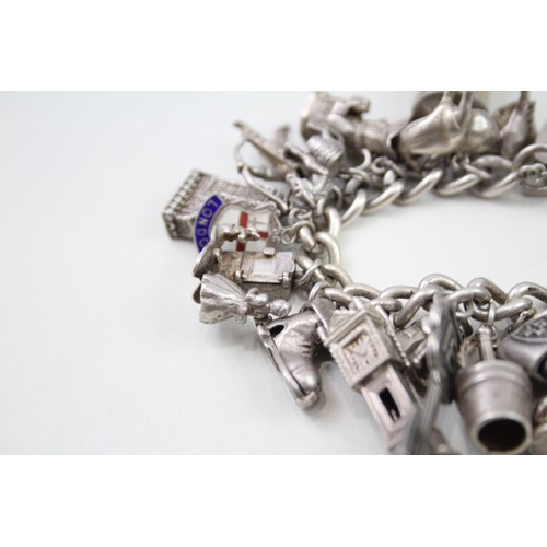 421 - Silver charm bracelet including emergency money charms (128g)