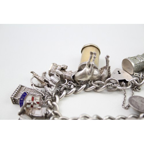 421 - Silver charm bracelet including emergency money charms (128g)