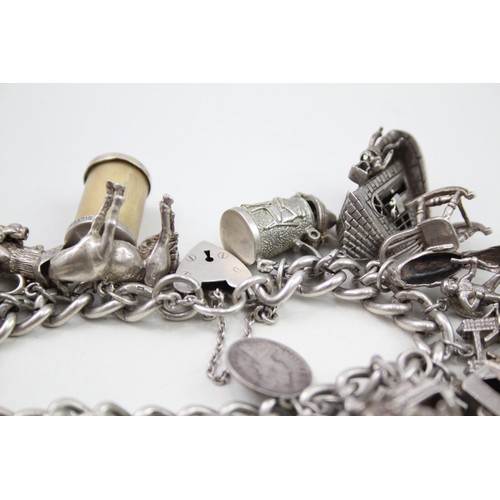 421 - Silver charm bracelet including emergency money charms (128g)