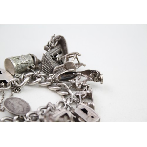 421 - Silver charm bracelet including emergency money charms (128g)