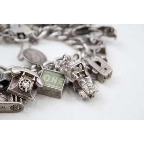 421 - Silver charm bracelet including emergency money charms (128g)