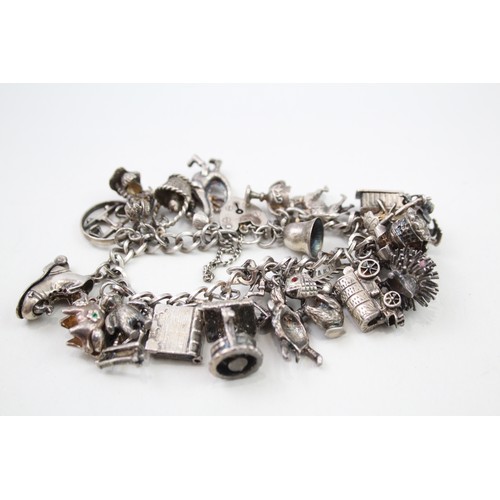 431 - Silver charm bracelet including quirky charms (79g)