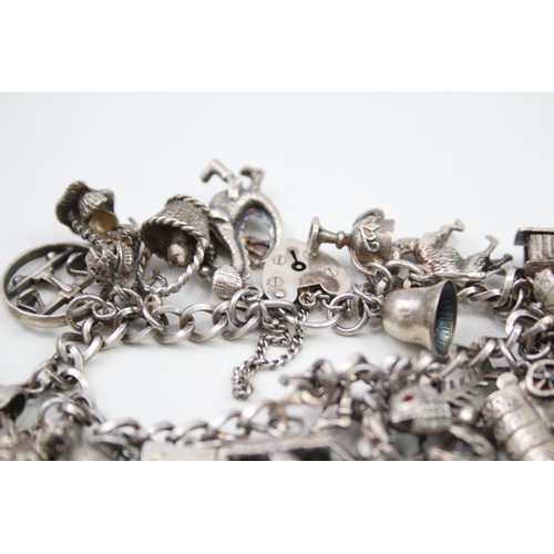 431 - Silver charm bracelet including quirky charms (79g)