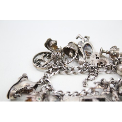 431 - Silver charm bracelet including quirky charms (79g)