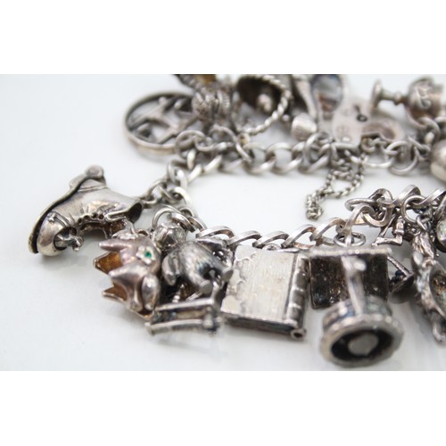 431 - Silver charm bracelet including quirky charms (79g)