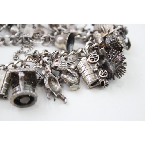 431 - Silver charm bracelet including quirky charms (79g)