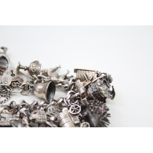 431 - Silver charm bracelet including quirky charms (79g)