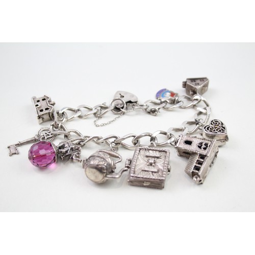 432 - Silver charm bracelet with opening charms (68g)