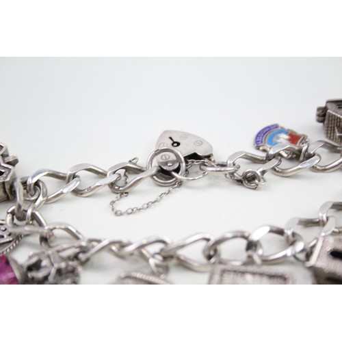 432 - Silver charm bracelet with opening charms (68g)