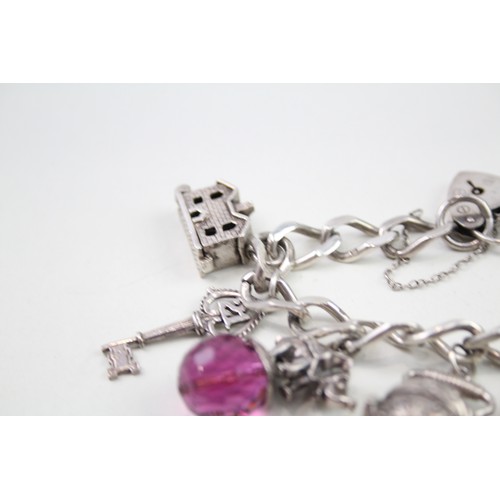 432 - Silver charm bracelet with opening charms (68g)