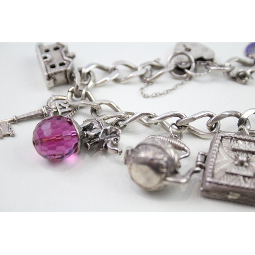 432 - Silver charm bracelet with opening charms (68g)