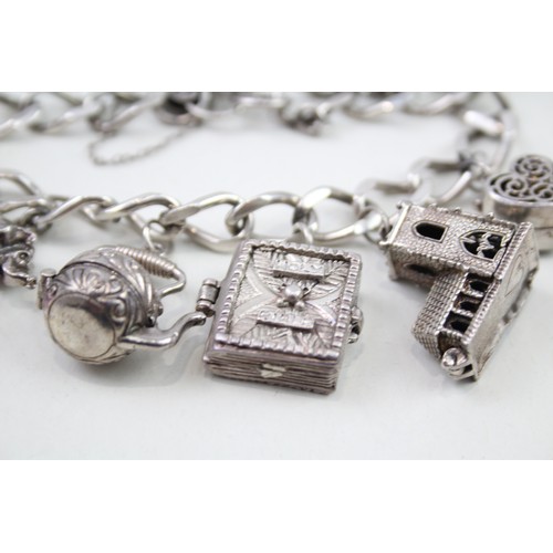 432 - Silver charm bracelet with opening charms (68g)