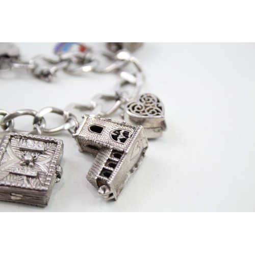 432 - Silver charm bracelet with opening charms (68g)